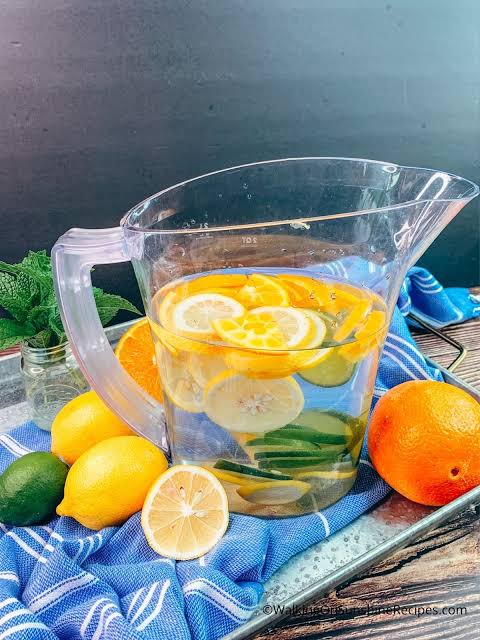 Fresh clean water with citrus slices in a glass jug